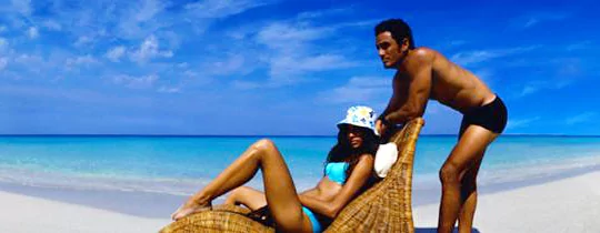 Couple laying on the beach image.