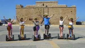 Group of people on segways taking a picture.